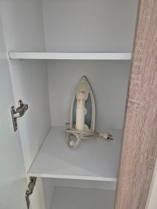 a white shelf with a hair dryer on it at Ferienwohnung/Apartment Siegen in Siegen