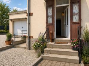 a front door of a house with stairs and flowers at Entre Rails & Rives in Montbard