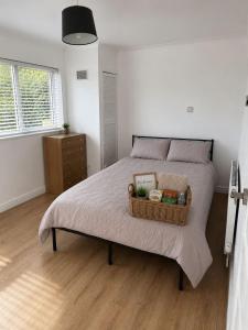 a bedroom with a bed with a basket on it at Stylish 4BR Home - Sleeps 7 - Parking & WiFi in Nottingham
