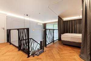 a bedroom with a bed and a staircase in a room at Amber Elite Apartments in Stegna