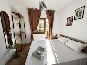 a bedroom with a bed with two towels on it at Legend Suites Bitola in Bitola