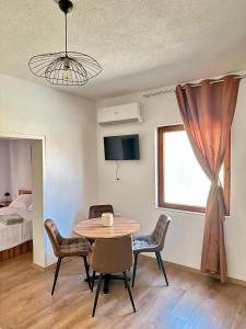 a room with a table and chairs and a bed at Legend Suites Bitola in Bitola