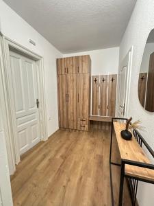 an empty room with wooden cabinets and a table at Legend Suites Bitola in Bitola +110 photos