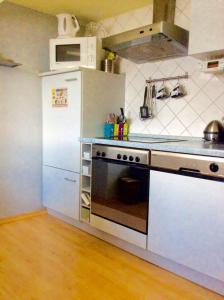 a kitchen with a stove and a refrigerator at Stadtblick in Cochem