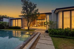 a house with a swimming pool in front of it at Botanica Foresta Luxury Villa Phuket in Phuket