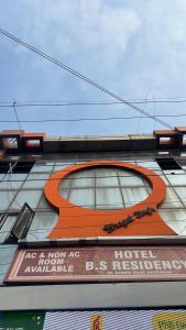 an orange sign on the side of a building at BS Residency in Dehradun