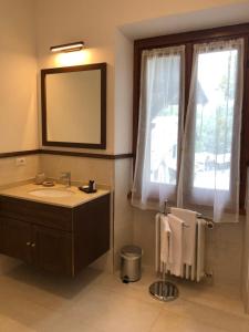 a bathroom with a sink and a mirror and a window at The Golf Club Guest House in Menaggio +30 photos