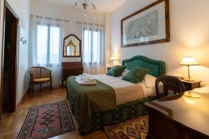 a bedroom with a bed and a table and a chair at Locanda Confini in Dolo