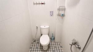 a small bathroom with a toilet in a stall at Griya Mentari Homestay in Yogyakarta +3 photos
