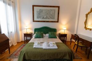 a bedroom with a bed with two towels on it at Locanda Confini in Dolo