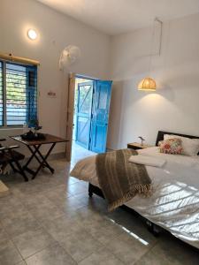 a bedroom with a bed and a table in it at Aranya Tara in Bhīm Tāl