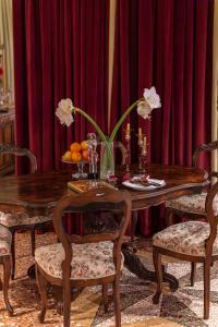 a dining room with a wooden table with flowers on it at Locanda Confini in Dolo