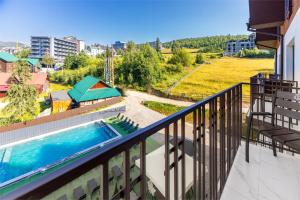 a balcony with a swimming pool on top of a building at Imperial Hotel in Bukovel