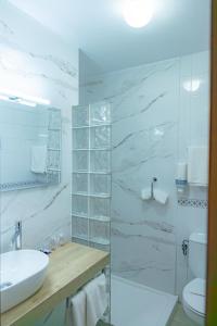 a white bathroom with a sink and a toilet at Hotel Solatorre in Comillas +92 photos