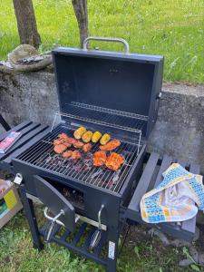 a grill with food cooking on it in the grass at Landhaus Lerch in Gaschurn