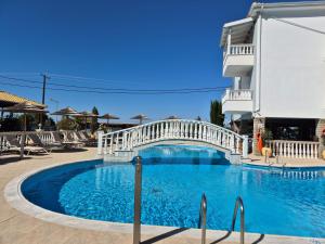 a bridge over a swimming pool in a resort at Sigma Hotel in Paralia Vrachou