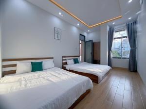 a bedroom with two beds and a window at Arden Reserve Villa in Binh Thai +50 photos