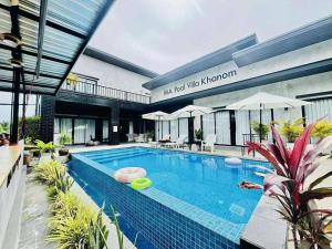 a swimming pool with a frisbee in front of a building at Ma PoolVilla Khanom in Khanom