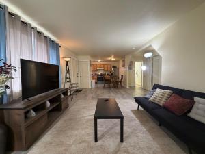 a living room with a couch and a flat screen tv at Cozy Place in Anchorage