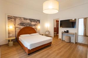 a bedroom with a large bed and a flat screen tv at Lina's Room in Cinisi