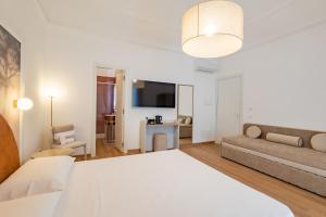 a living room with a bed and a couch at Lina's Room in Cinisi