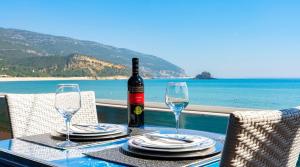 a table with a bottle of wine and two glasses at Luxury Villa with Private Pool e Jacuzzi Year-Round a 25 min de Lisboa in Setúbal +53 photos