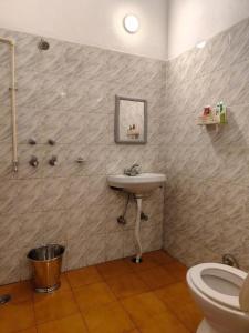a bathroom with a sink and a toilet at Aranya Tara in Bhīm Tāl +31 photos