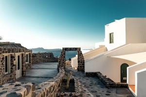 a walkway between buildings on the island of santorini at Epic View Suites in Akrotiri