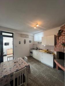 a kitchen with a table and a dining room at Apartmani Vinko Palaversić in Jelsa
