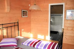 a bedroom with a bed in a room with wooden walls at Il Nido in Agra