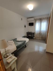 a hospital room with a bed and a table at El Sueño del Infante in Guadalajara