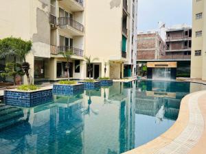 a swimming pool in the middle of a building at RADHEY RADHEY stays in Vrindāvan