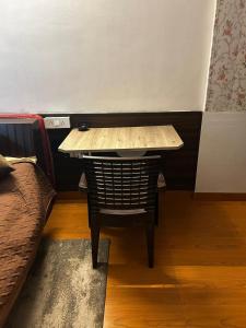 a small table and a chair in a room at RADHEY RADHEY stays in Vrindāvan