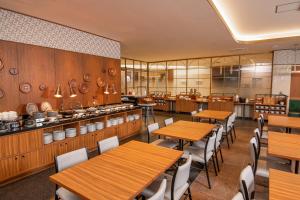 a dining room with wooden tables and chairs at HOTEL MYSTAYS Nippori in Tokyo