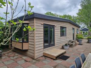 a tiny house sitting on a patio at Nieuw chalet in Nunspeet in Nunspeet