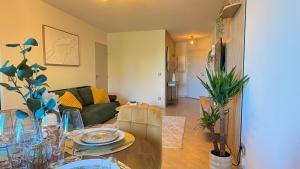 a living room with a table and a couch at Riviera Heights Monaco in Beausoleil
