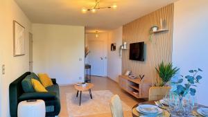a living room with a couch and a table at Riviera Heights Monaco in Beausoleil