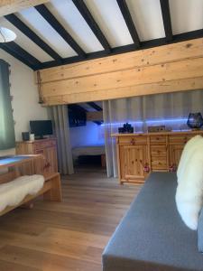 a large room with a bed and wooden furniture at Bouquetin studio cosy in Notre-Dame-de-Bellecombe