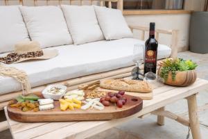 a table with a tray of food and a bottle of wine at סוויטת דרים רויאל - סוויטה חלומית עם אמבט ספא מפנק ונוף מדהים in ‘Ein Ya‘aqov