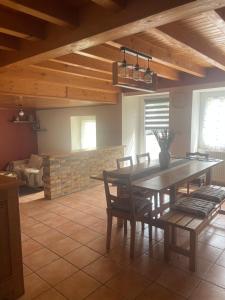 a dining room with a table and chairs and a couch at La Salamandre in Valprivas