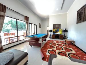 a living room with a pool table in it at MP Villa Tirta Sevil S3 Malang in Mantaak