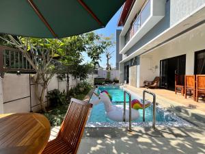 a pool with a toy unicorn in a swimming pool at MP Villa Tirta Sevil S3 Malang in Mantaak