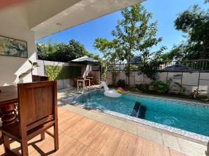 a swimming pool with a swan in a house at MP Villa Tirta Sevil S3 Malang in Mantaak