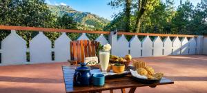 a tray of food on a table on a patio at Aranya Tara in Bhīm Tāl