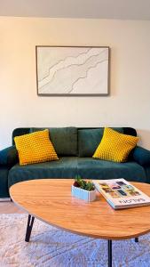 a living room with a green couch and a coffee table at Riviera Heights Monaco in Beausoleil