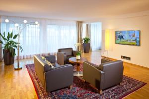 a living room with couches and a table at Hotel Penz West in Innsbruck