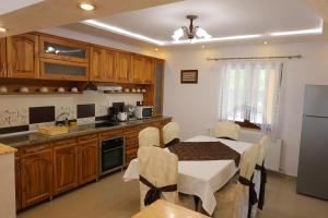 a kitchen with a table and a dining room at Cabana Sargetia in Costeşti