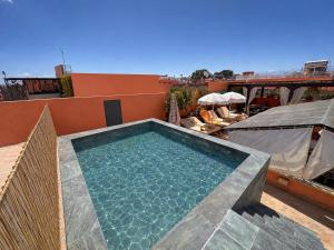 a swimming pool sitting on top of a building at Riad Nirvana in Marrakesh