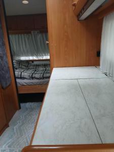 a small room with a bed and a window at Túrkeve Lakó in Túrkeve