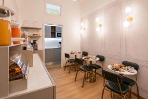 a kitchen with two tables and chairs in a room at Lina's Room in Cinisi